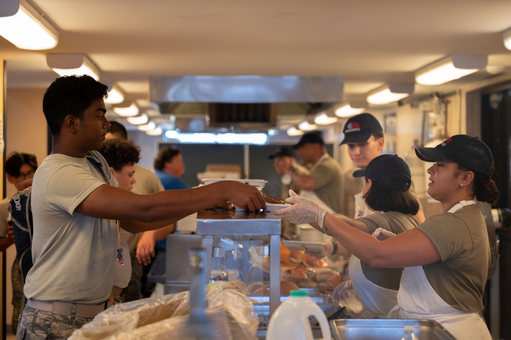 Services specialists prepare meals for Civil Air Patrol cadets