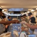 Services specialists prepare meals for Civil Air Patrol cadets