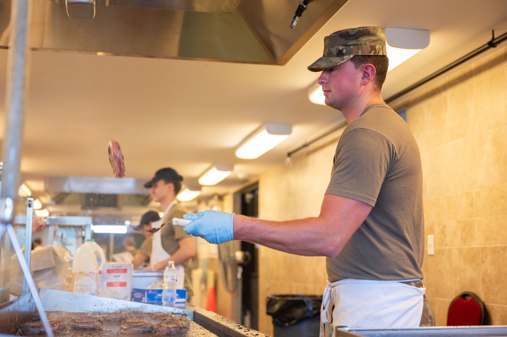 Services specialists prepare meals for Civil Air Patrol cadets