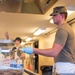 Services specialists prepare meals for Civil Air Patrol cadets