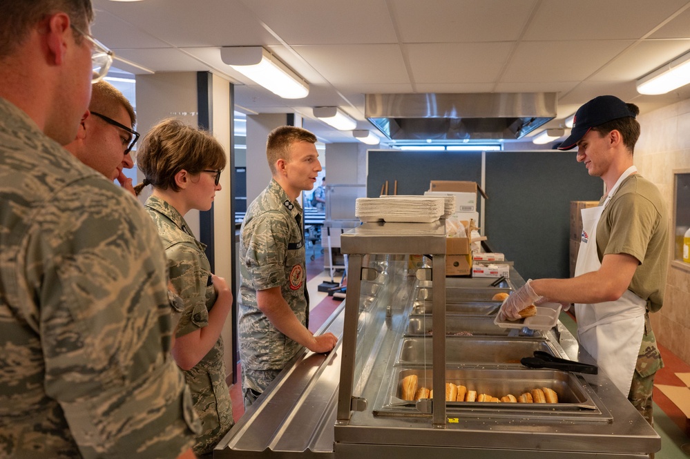 Services specialists prepare meals for Civil Air Patrol cadets