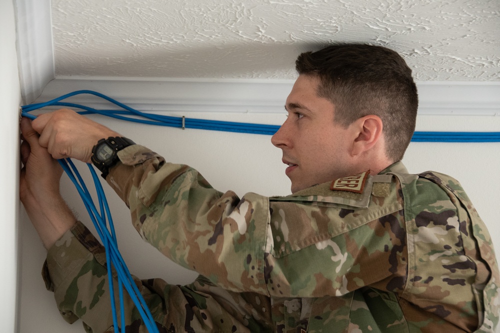 U.S. Staff Sgt. Timothy Winkler runs all new cables and networks in a new Tribal Health IT building