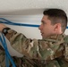 U.S. Staff Sgt. Timothy Winkler runs all new cables and networks in a new Tribal Health IT building