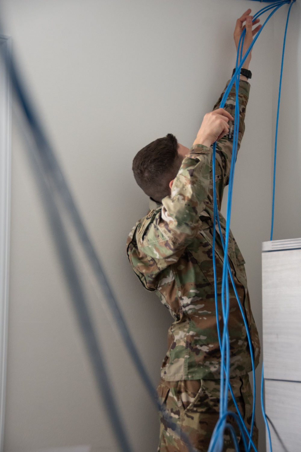 U.S. Air Force Staff Sgt. Timothy Winkler runs all new wires and networks in a new Blackfeet Tribal Health IT building