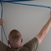 U.S. Air Force Staff Sgt. Braydon Dotson assists fellow service members in a rewiring project for the Blackfeet Tribal Health IT Department