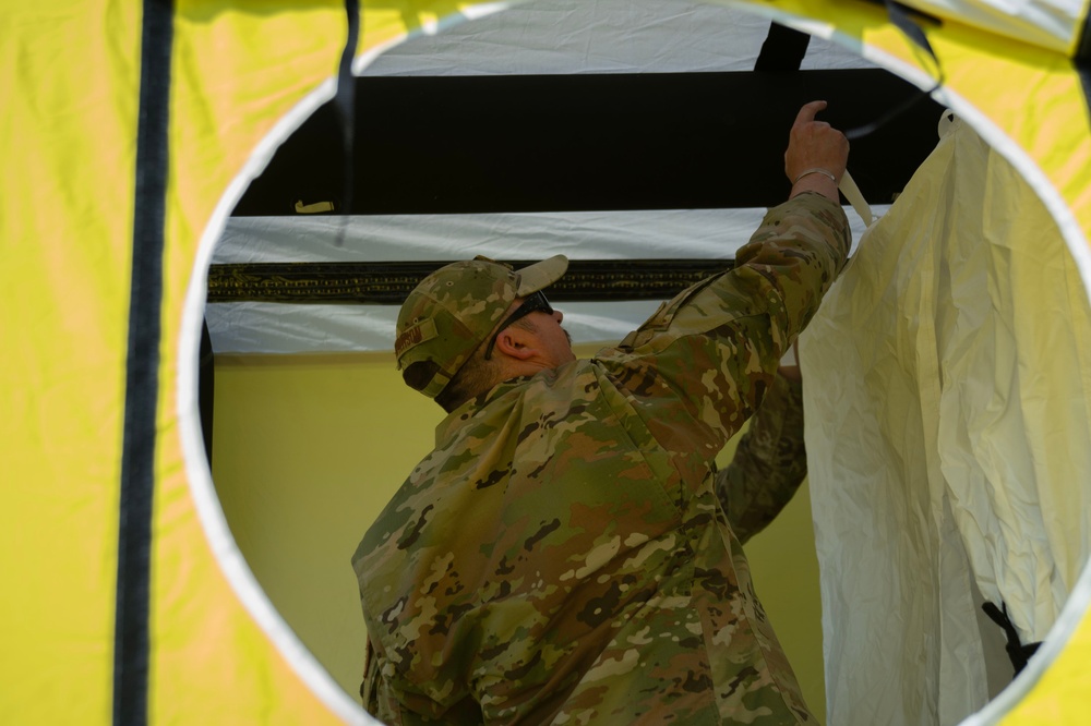 U.S. Air Force Maj. Stephen Kesterson and Capt. James Hanes set up a decontamination tent on Blackfeet Indian Reservation