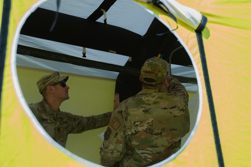 U.S. Air Force Maj. Stephen Kesterson and Capt. James Hanes set up a decontamination tent on Blackfeet Indian Reservation