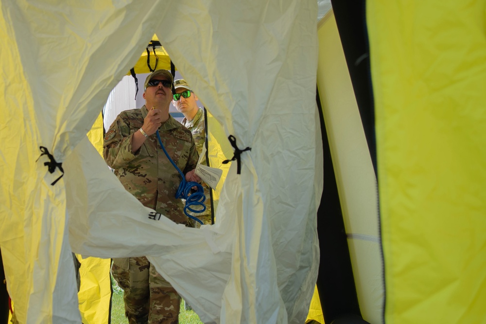 U.S. Air Force Maj. Stephen Kesterson and Capt. James Hanes set up a decontamination tent on Blackfeet Indian Reservation