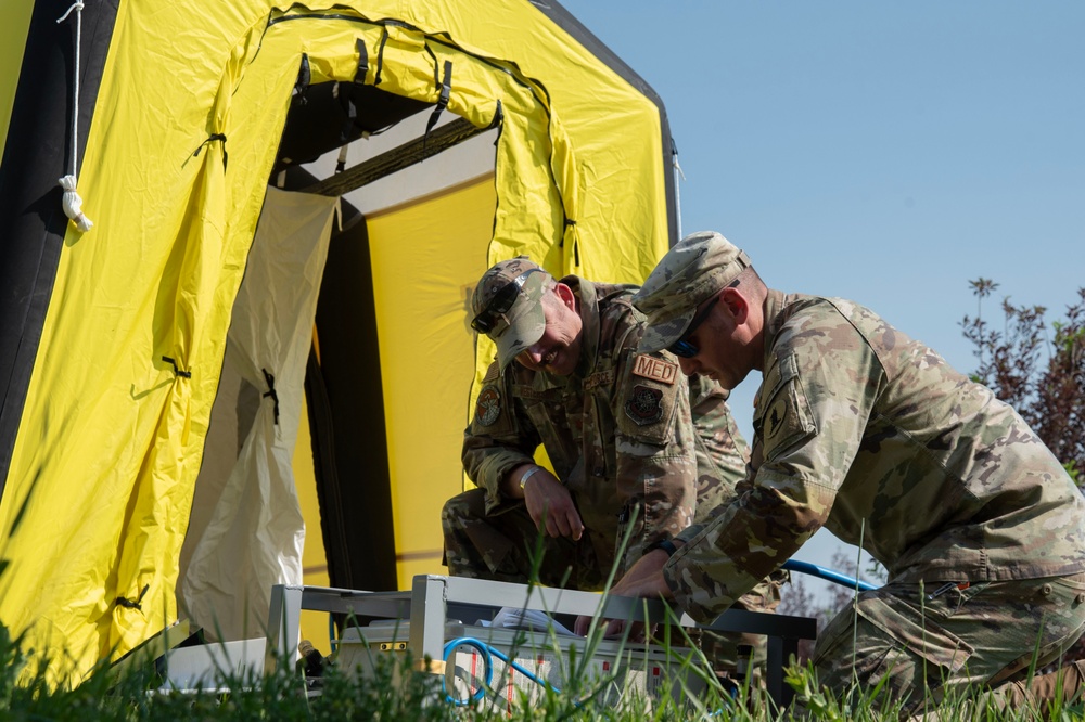 U.S. Air Force Maj. Stephen Kesterson and Capt. James Hanes set up a decontamination tent on Blackfeet Indian Reservation