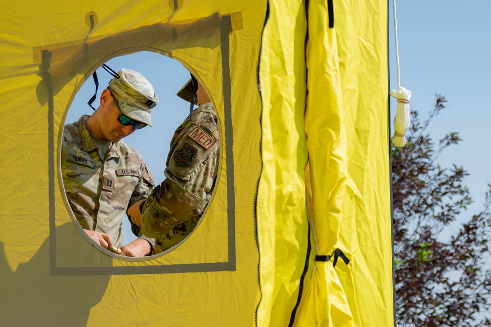 U.S. Air Force Maj. Stephen Kesterson and Capt. James Hanes set up a decontamination tent on Blackfeet Indian Reservation