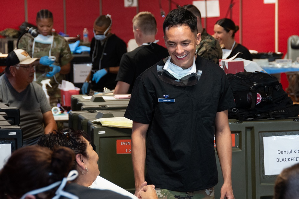 U.S. Air Force Airman 1st Class Edmond Thompson greets a patient during a no-cost medical clinic.