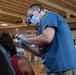 U.S. Air Force Capt. Bill Rysenga provides dental care to a patient during the Blackfeet Tribal Health - Operation Walking Shield