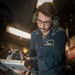 A Nimitz Sailor Grinds Sheet Metal