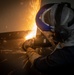 A Nimitz Sailor Grinds Metal From The Deckplates