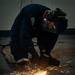 A Nimitz Sailor Grinds Metal From The Deckplates