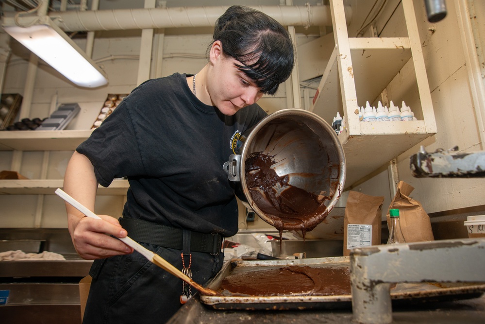 A Nimitz Sailor Pours Brownie Batter