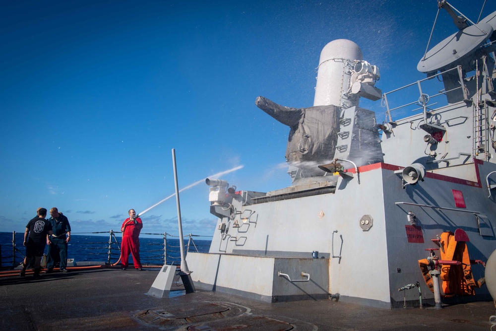 Sailor Aboard Arleigh Burke-Class Guided-Missile Destroyer USS Kidd (DDG 100) Washes a Close-In Weapons System