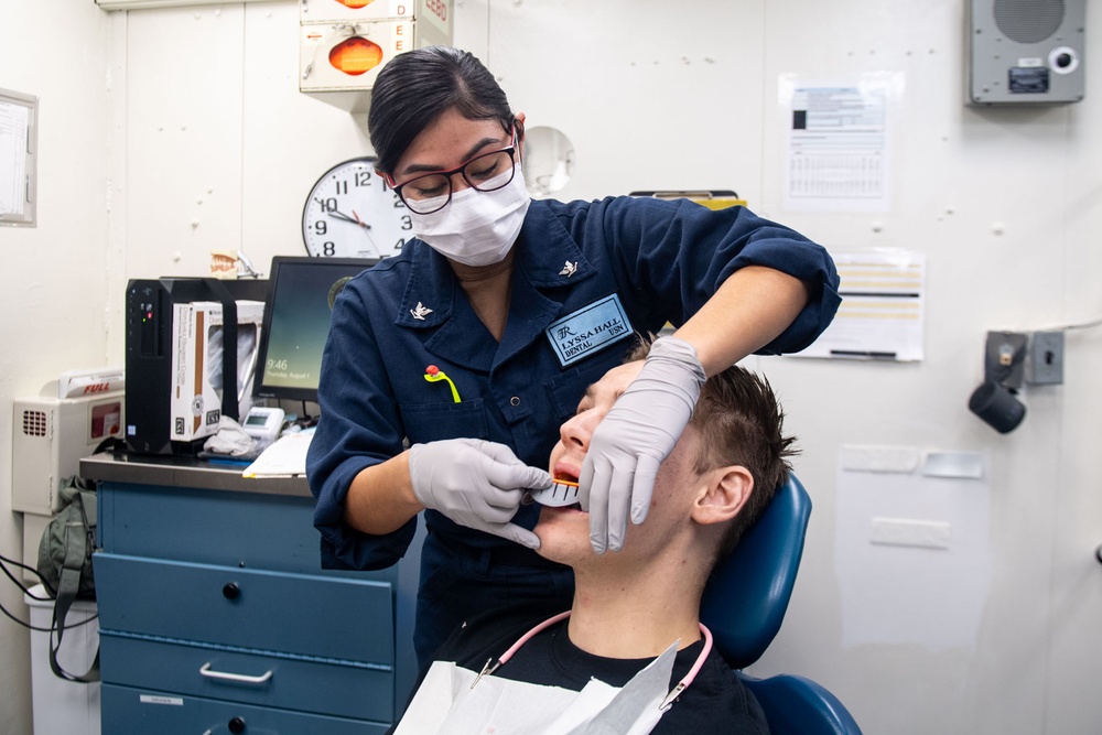 USS Theodore Roosevelt Hospital Corpsman Conducts Dental Care for Sailors