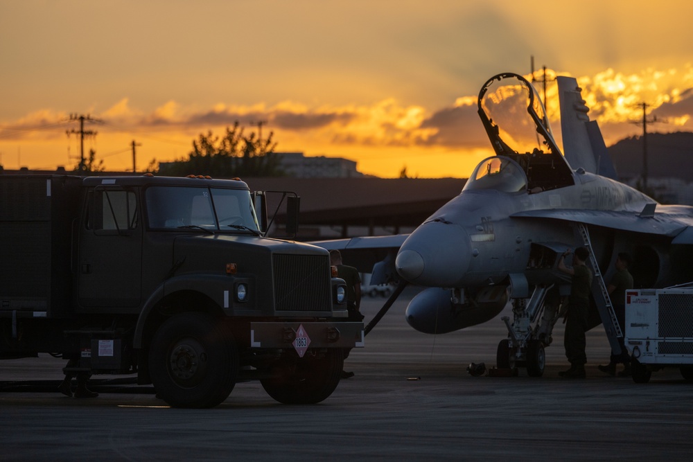 U.S. Marines with VMFA(AW) 224 maintain F/A-18 Hornet Aircraft after flight operations at Suwon AB