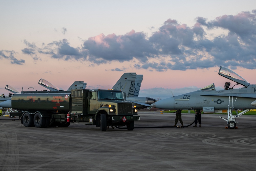 U.S. Marines with VMFA(AW) 224 maintain F/A-18 Hornet Aircraft after flight operations at Suwon AB