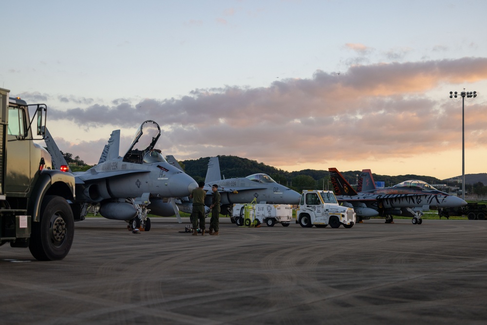 U.S. Marines with VMFA(AW) 224 maintain F/A-18 Hornet Aircraft after flight operations at Suwon AB