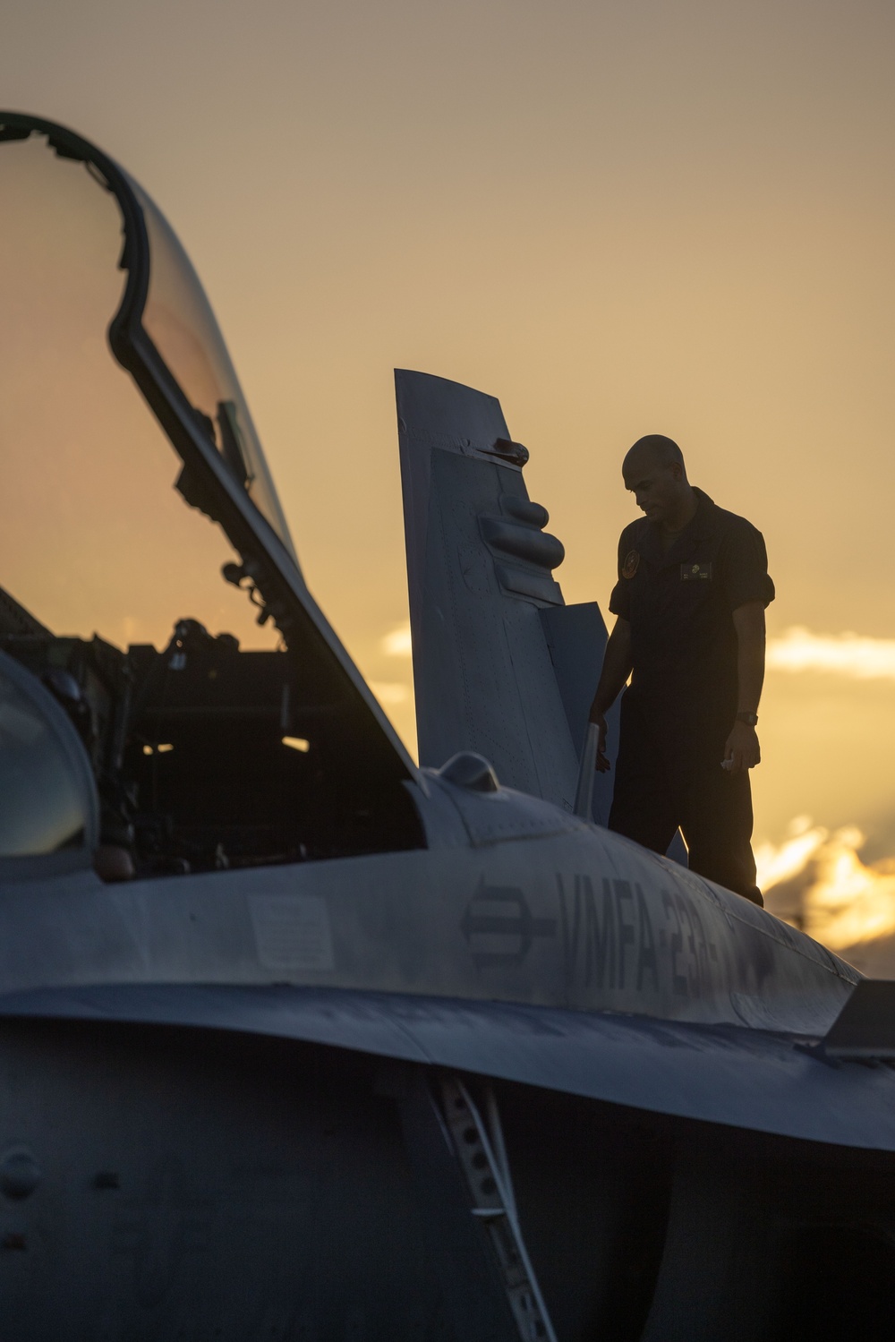 U.S. Marines with VMFA(AW) 224 maintain F/A-18 Hornet Aircraft after flight operations at Suwon AB