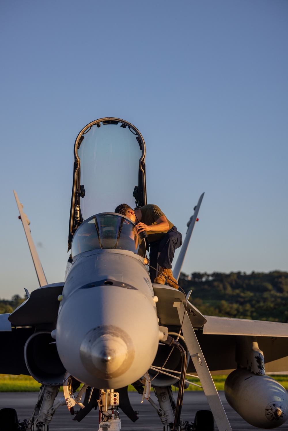 U.S. Marines with VMFA(AW) 224 maintain F/A-18 Hornet Aircraft after flight operations at Suwon AB