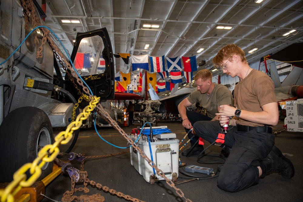 Sailors Aboard USS Carl Vinson (CVN 70) Conduct Maintenance on an MH-60S Sea Hawk
