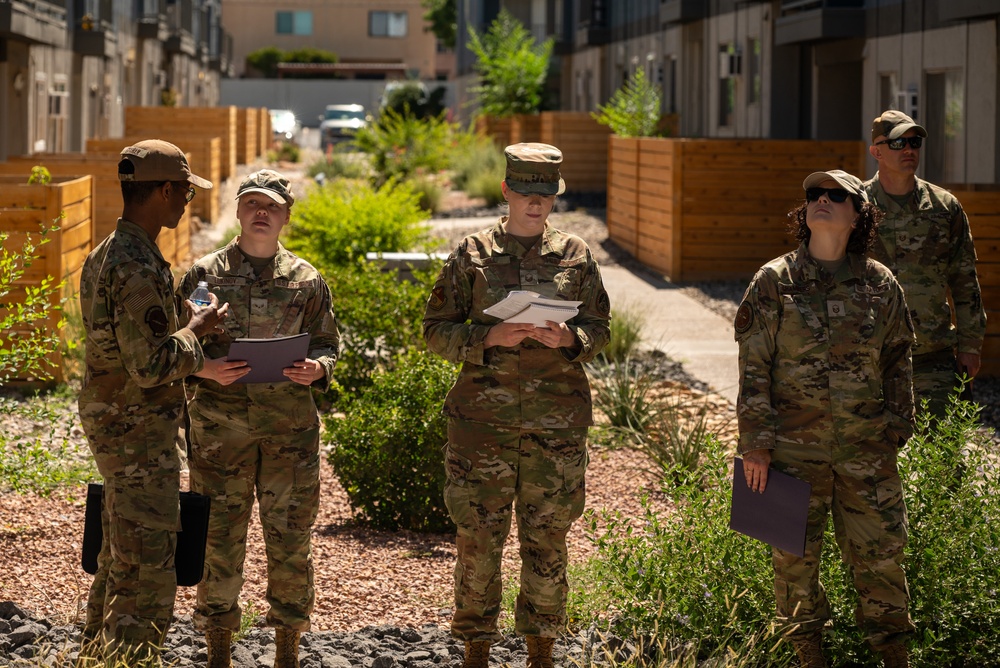 Airmen from the 377th Air Base Wing gather inspect common areas at a local apartment complex