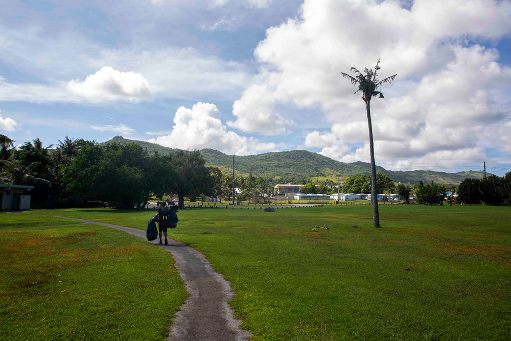 Sailors participate in a volunteer beach clean-up