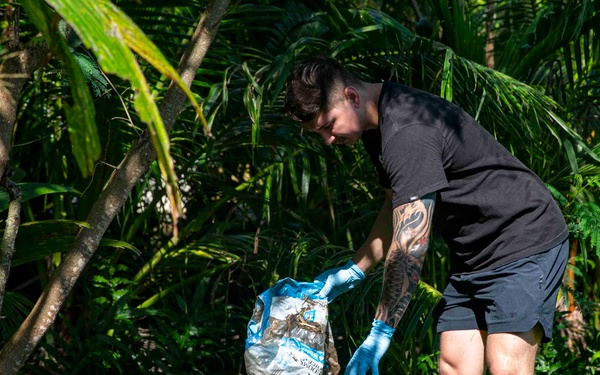 Sailors participate in a volunteer beach clean-up