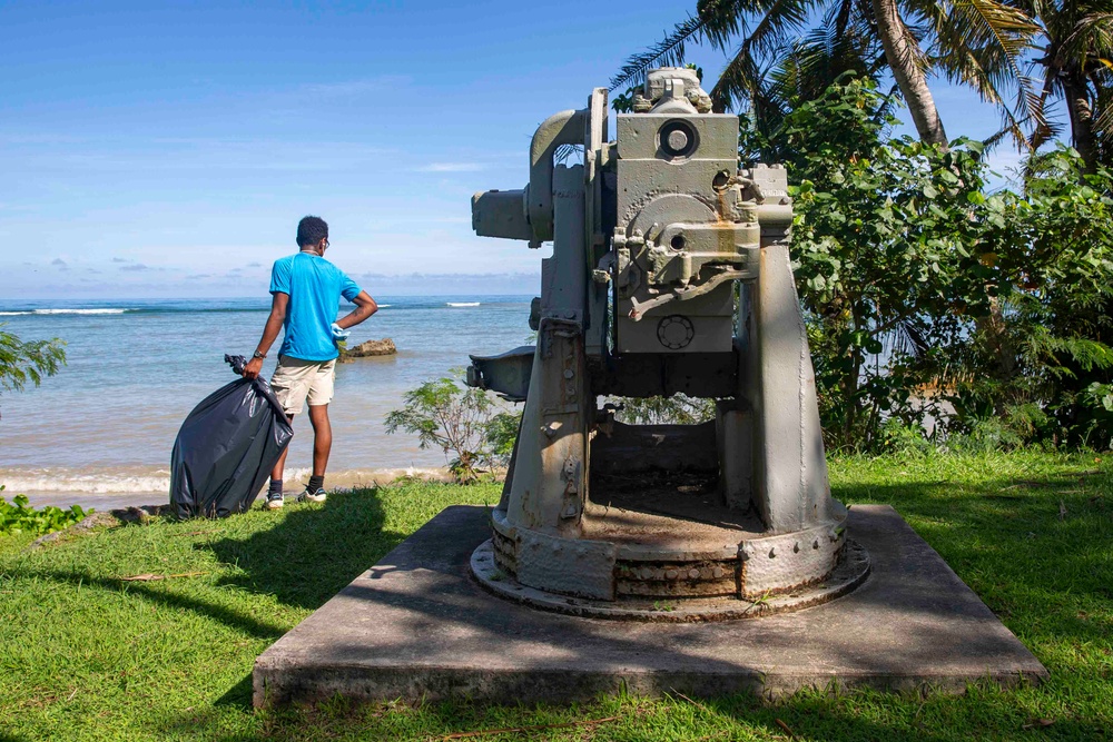 Sailors participate in a volunteer beach clean-up