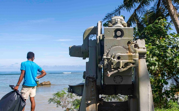 Sailors participate in a volunteer beach clean-up