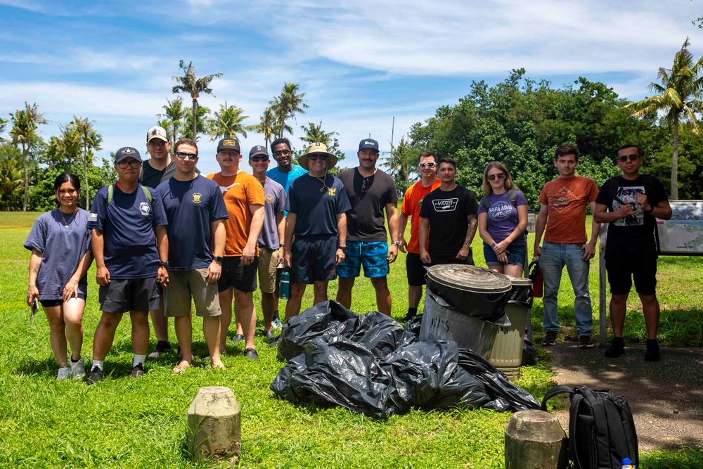 Sailors participate in a volunteer beach clean-up