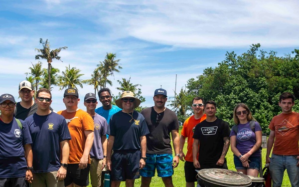 Sailors participate in a volunteer beach clean-up