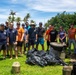 Sailors participate in a volunteer beach clean-up