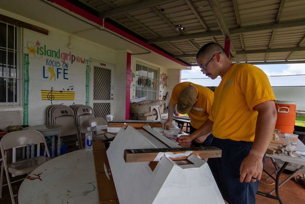 Sailors participate in a community outreach program with Island Girl Power