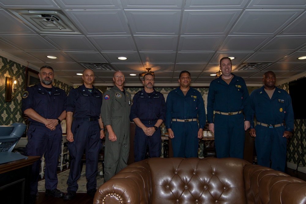 Rear Adm. Cruz and Rear Adm. Ciappina pose for a photo with staff aboard Abraham Lincoln