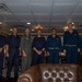 Rear Adm. Cruz and Rear Adm. Ciappina pose for a photo with staff aboard Abraham Lincoln