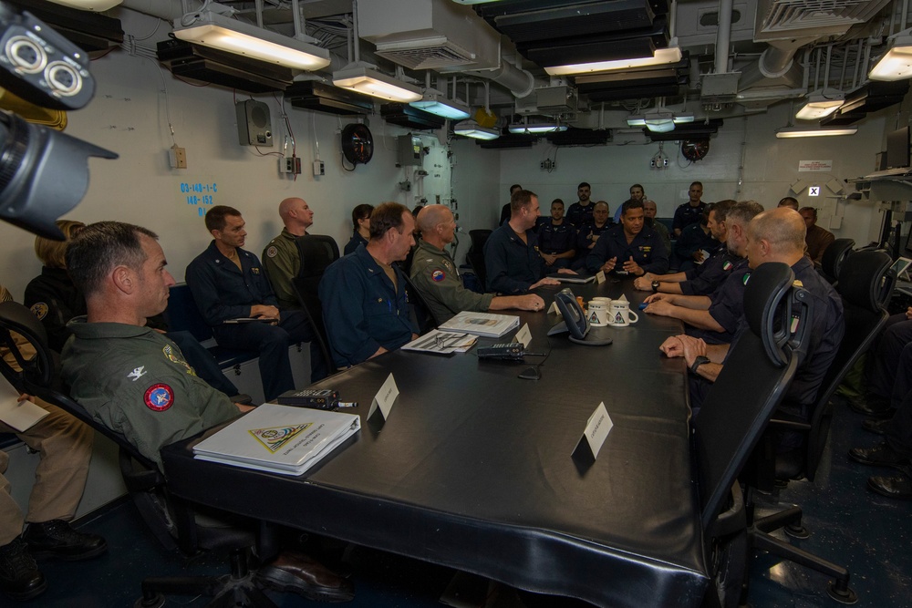 Rear Adm. Cruz and Rear Adm. Ciappina attend a meeting with staff aboard Abraham Lincoln