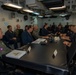 Rear Adm. Cruz and Rear Adm. Ciappina attend a meeting with staff aboard Abraham Lincoln