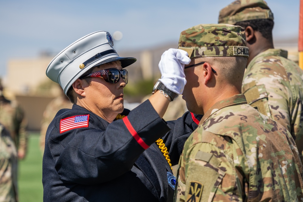 Mother pins new rank on son in emotional promotion ceremony