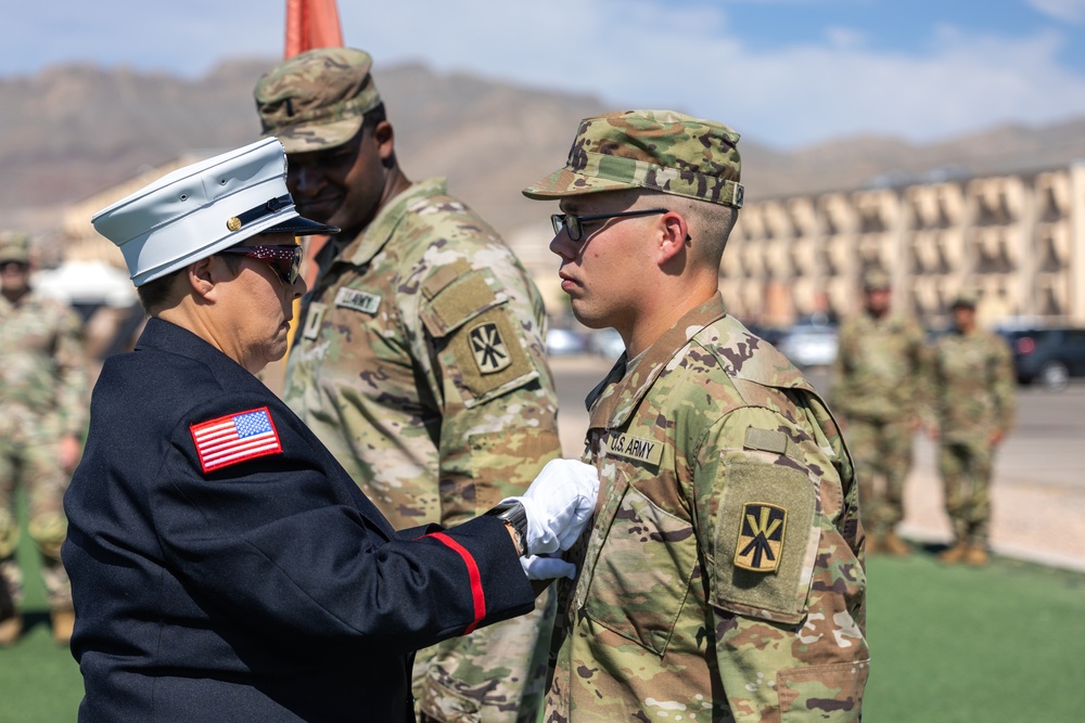 Mother pins new rank on son in emotional promotion ceremony