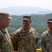 1st Armored Brigade Combat Team command team presents coins to service members during Operation Pacific Fortitude
