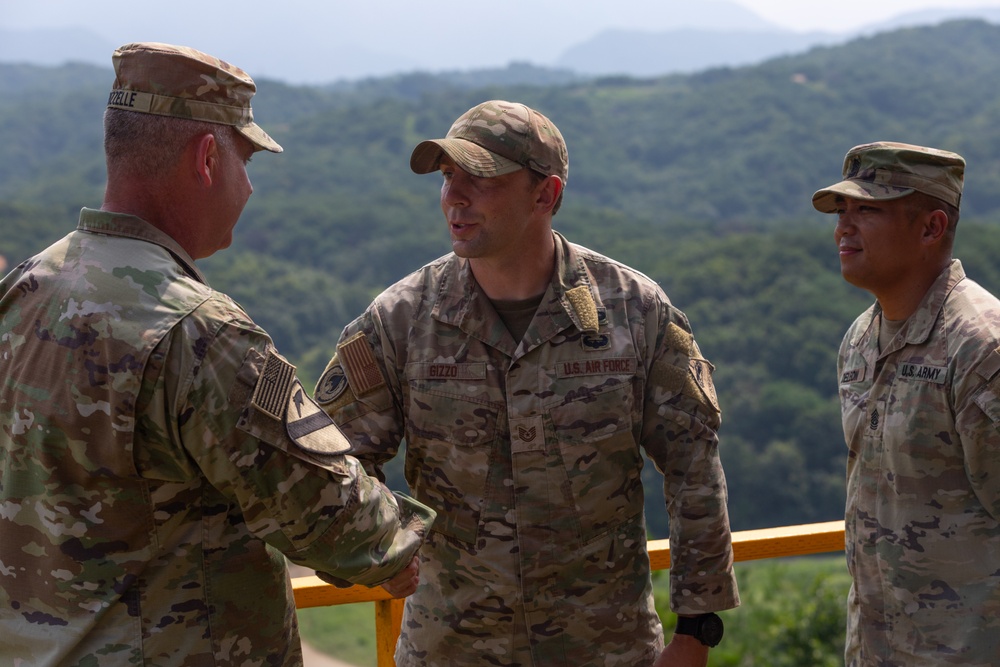 1st Armored Brigade Combat Team command team presents coins to service members during Operation Pacific Fortitude