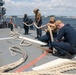Sailors aboard the USS Howard conduct a sea and anchor detail in Yokosuka, Japan