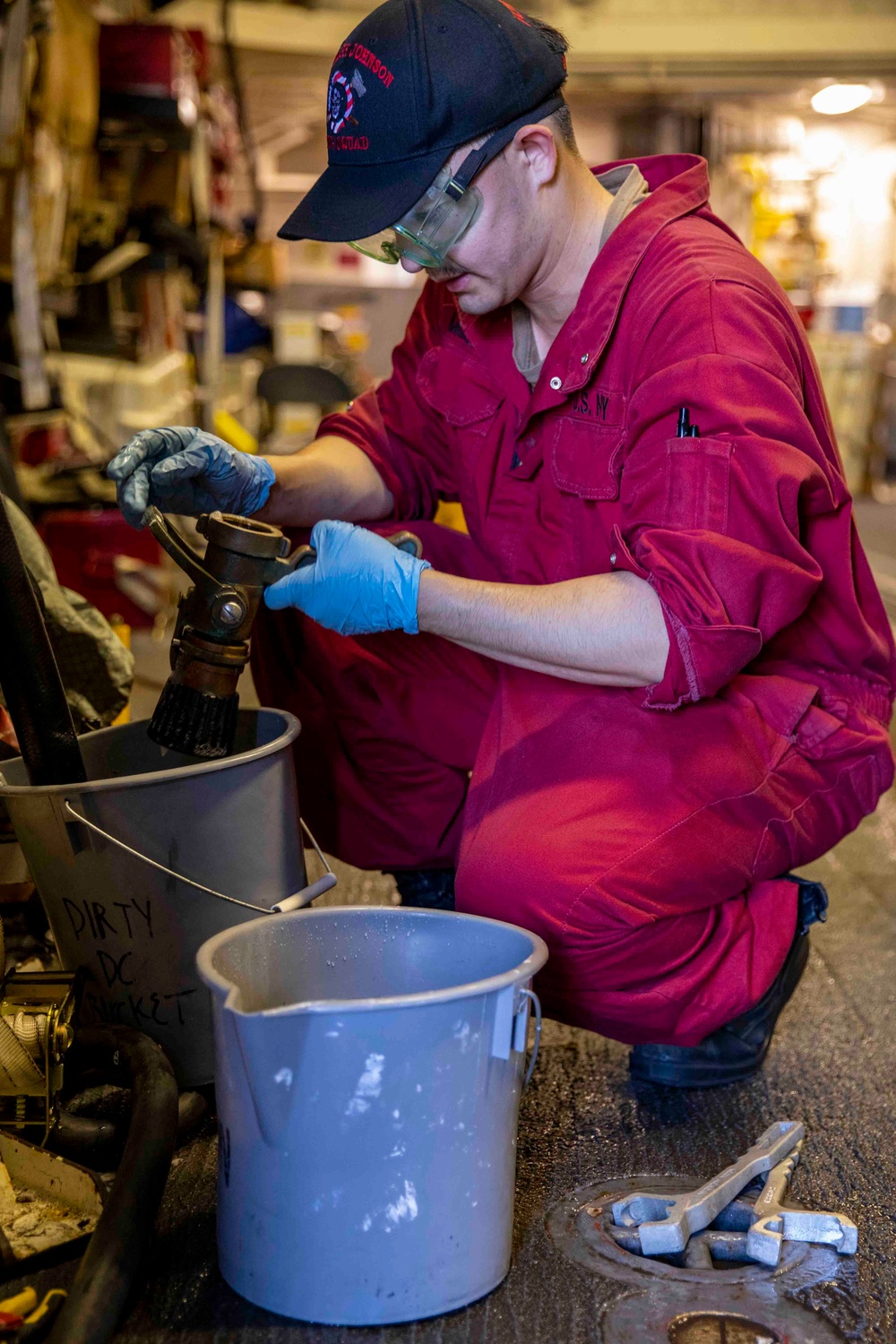 USS Ralph Johnson Sailor Conducts Maintenance