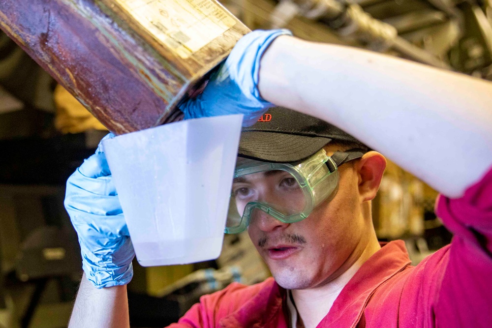 USS Ralph Johnson Sailor Conducts Maintenance