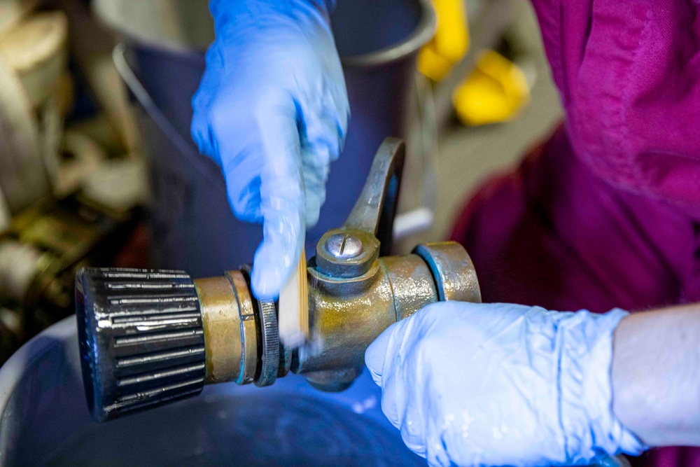 USS Ralph Johnson Sailor Conducts Maintenance