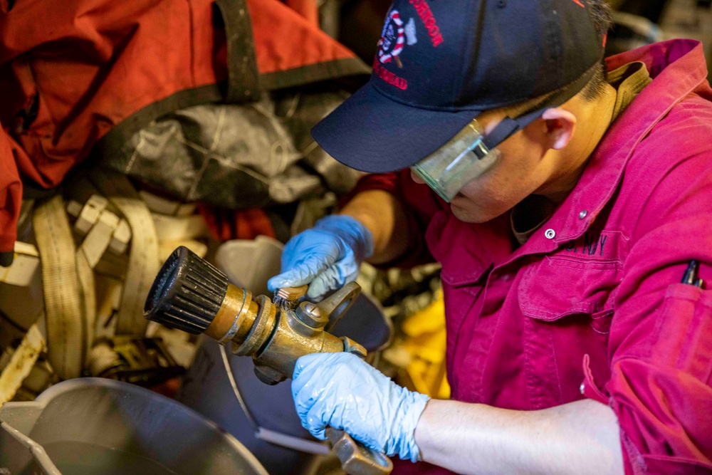 USS Ralph Johnson Sailor Conducts Maintenance